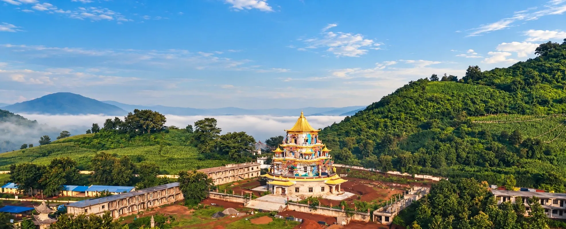 Zangdok Palri temple with its golden roofs rising above the mist at Dundul Raptenling Monastery